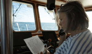 Christy Donnelly operating as net controller for the 0800 roll call during the 2019 CUBAR cruise in Mexican waters.