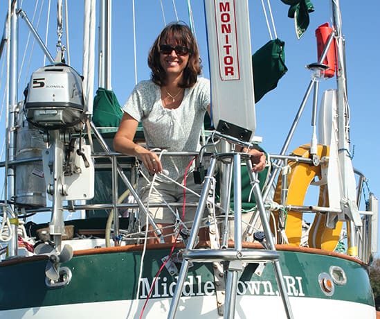 Rebecca Childress readies the wind vane self steering rig aboard her Valiant 40 Brick House.