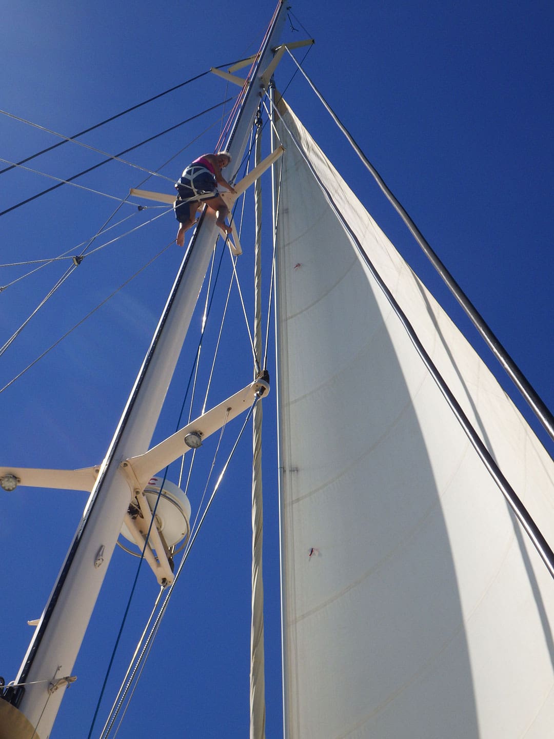 Lynne goes up the mast for a rigging check.