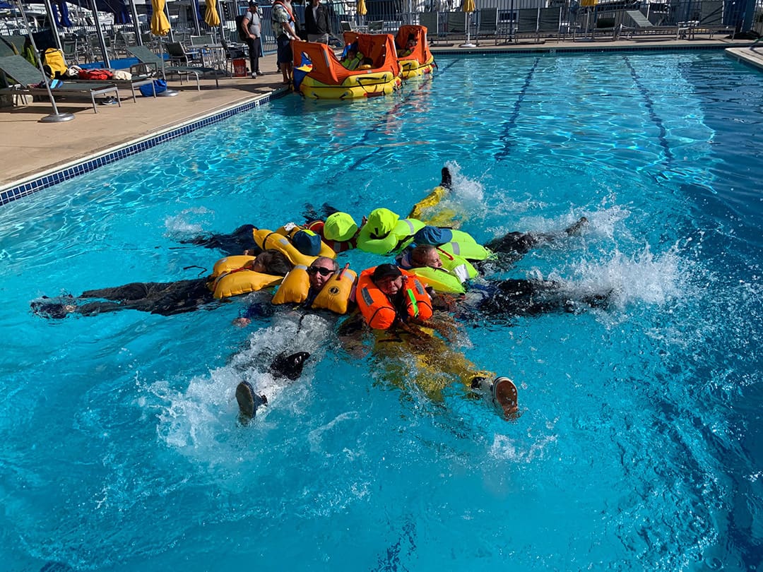 ,Participants in a Safety at Sea seminar get a chance to use inflatable life vests and practice safety techniques in the water.
