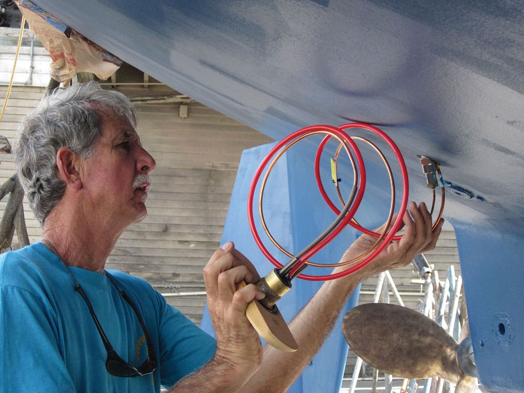 Dave McCampbell installing Frigoboat keel cooler tubing through a hull of his St. Francis 44 Mark II cat. Right, heat load in BTUs vs insulation thickness and R value for a freezer. Note curve flattening after R30.