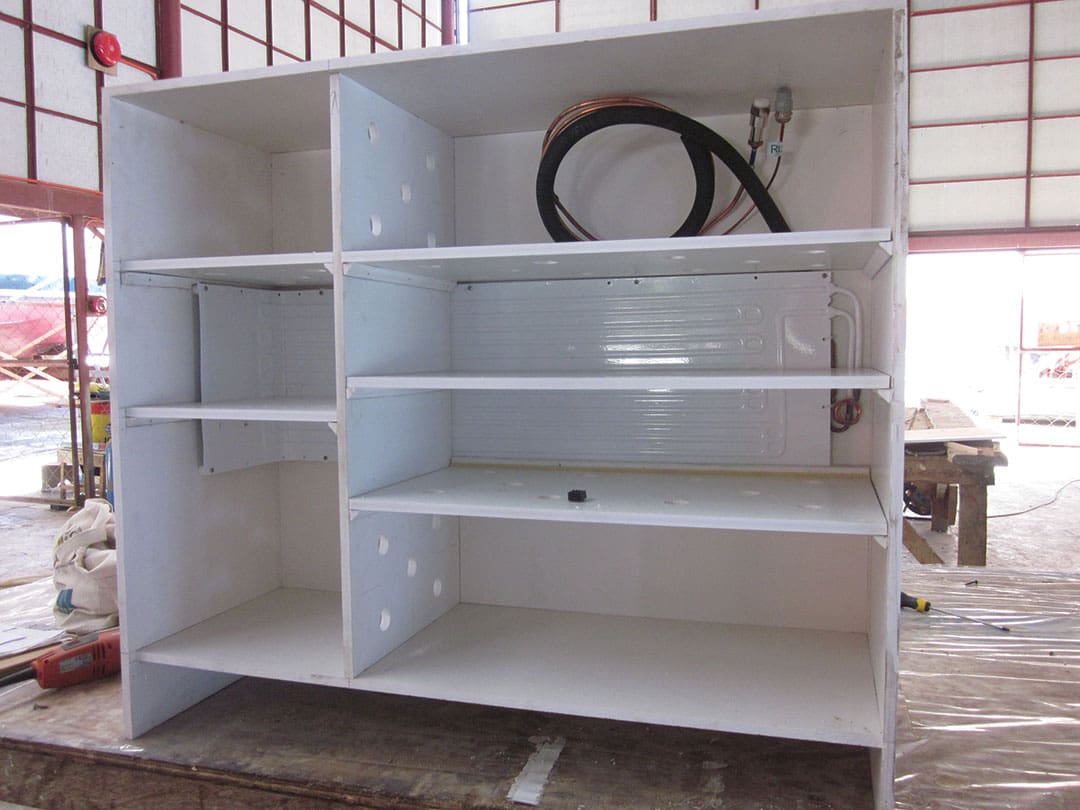 McCampbell’s eight-cubic-foot front opening refrigeration box under construction with evaporator plate and shelving in place.