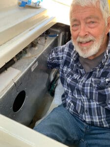 Harry Hungate demonstrating his boat’s new diesel fuel tank inspection ports.