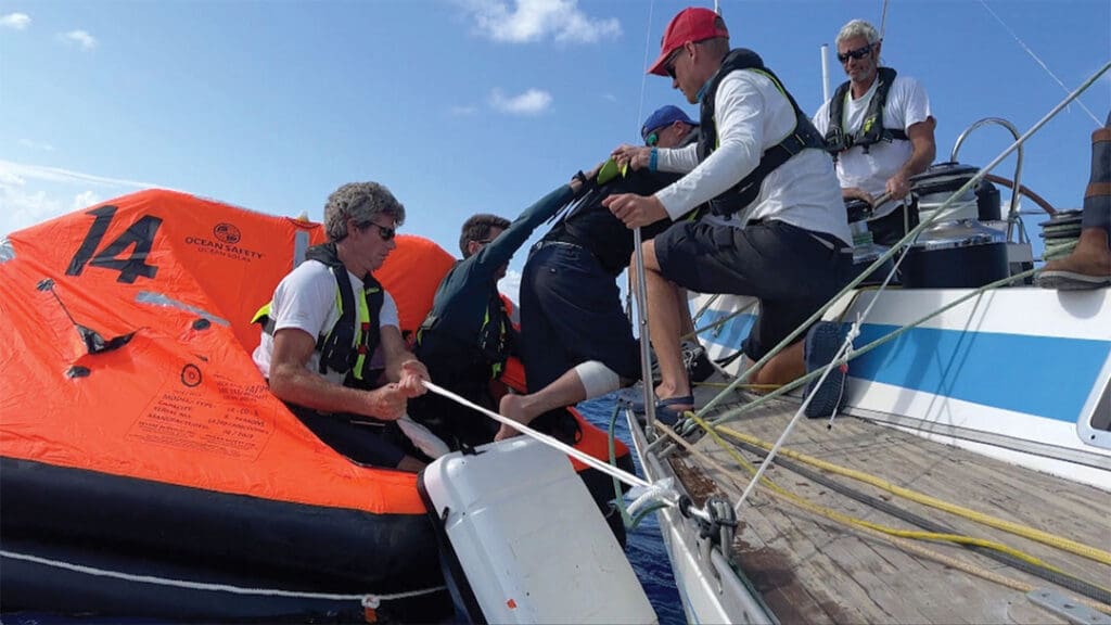 Injured racer is assisted into a life raft for helicopter evacuation off Madeira.