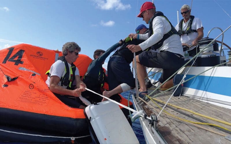Injured racer is assisted into a life raft for helicopter evacuation off Madeira.