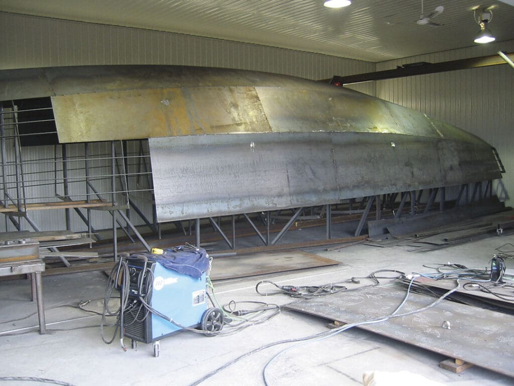 A steel sailboat under construction.