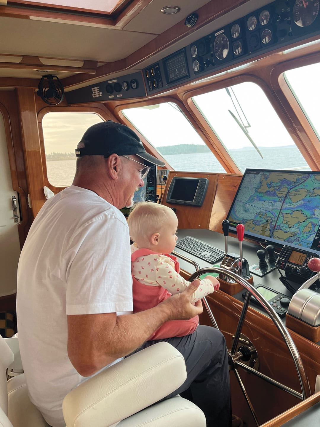 Dan Streech with grandchildren Isaac and Lilly in the pilothouse while underway.