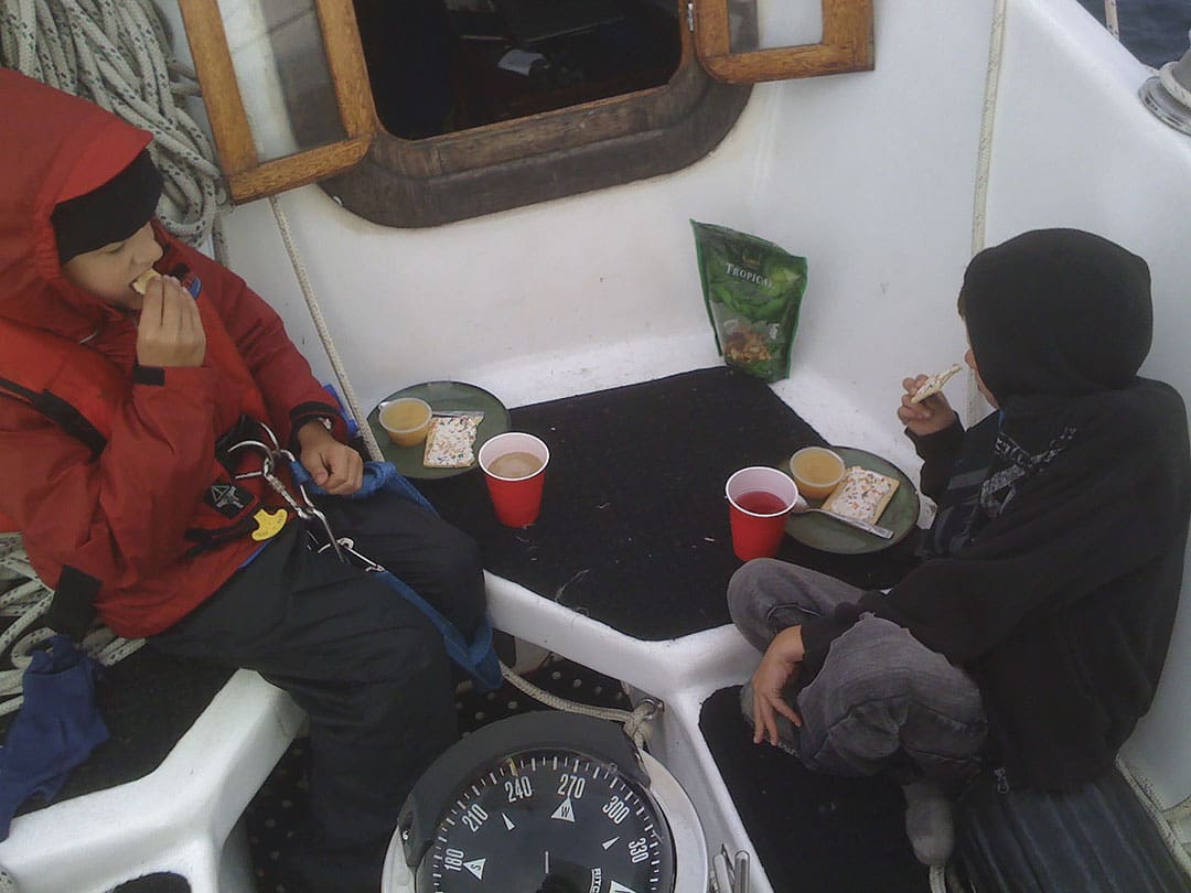 Isaac and Steven having a snack in the cockpit.