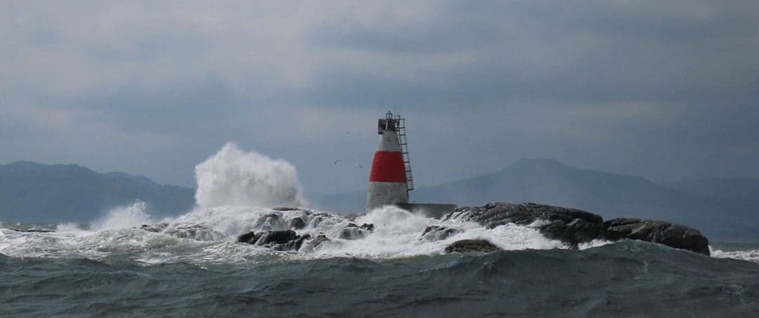 Waves exploding onto the rocks at Muglins Lighthouse just south of Dublin as the Hamiltons departed for Horta