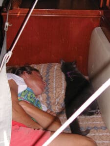 Ann and Pearl the cat asleep in Oddly Enough’s sea berth.