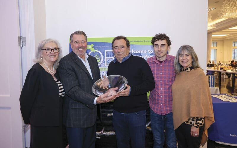 Warren Kelly (center) accepts the MMTA Frank Farrell Distinguished Service Award from Larry Russo, alongside (L to R) MMTA President Marie Hayward, Dylan Kelly and Lisa Kelly.
